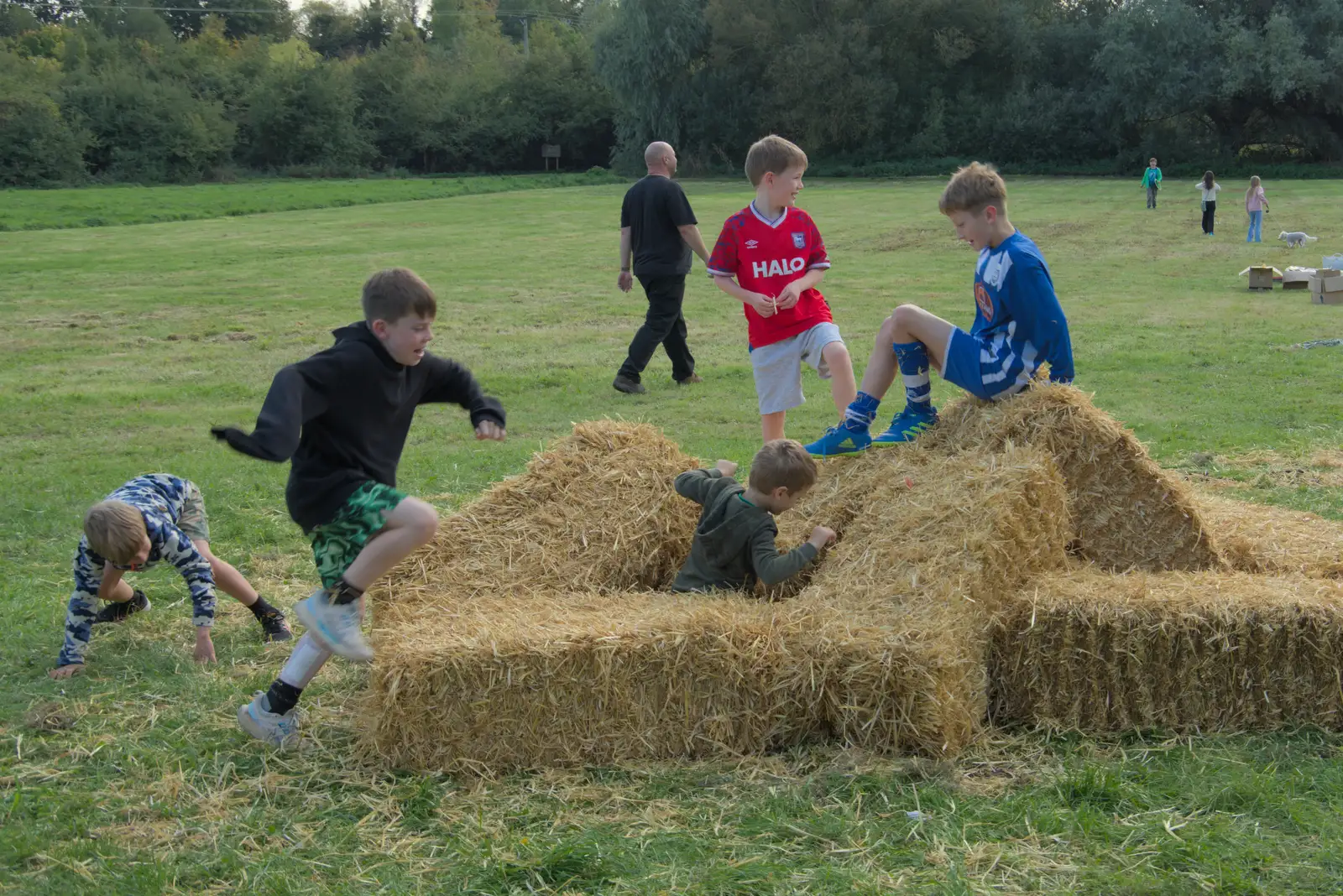 Boys work on destroying the straw bales, from The GSB at the Scouts' Duck Race, The Pennings, Eye - 27th September 2025