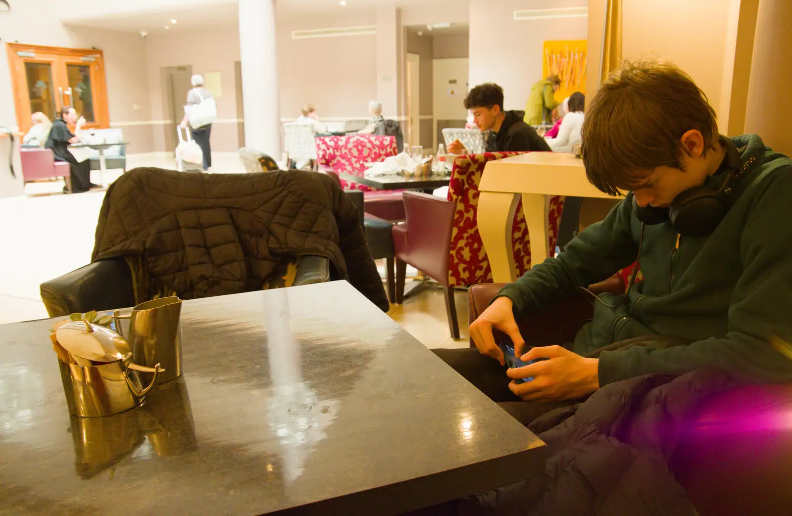 Harry's on his phone as wait for our room, from End of the Line 1: Dún Laoghaire to Howth, Ireland - 29th October 2025