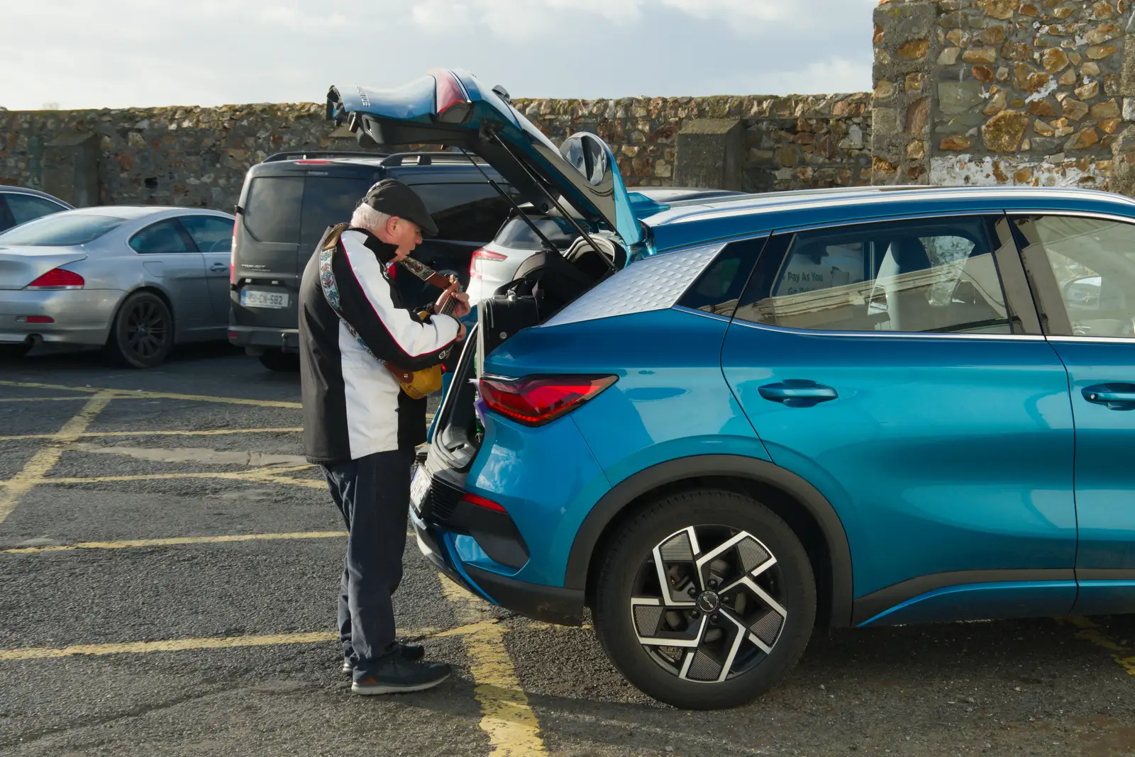 Some dude plays a ukulele by his car, from End of the Line 1: Dún Laoghaire to Howth, Ireland - 29th October 2025