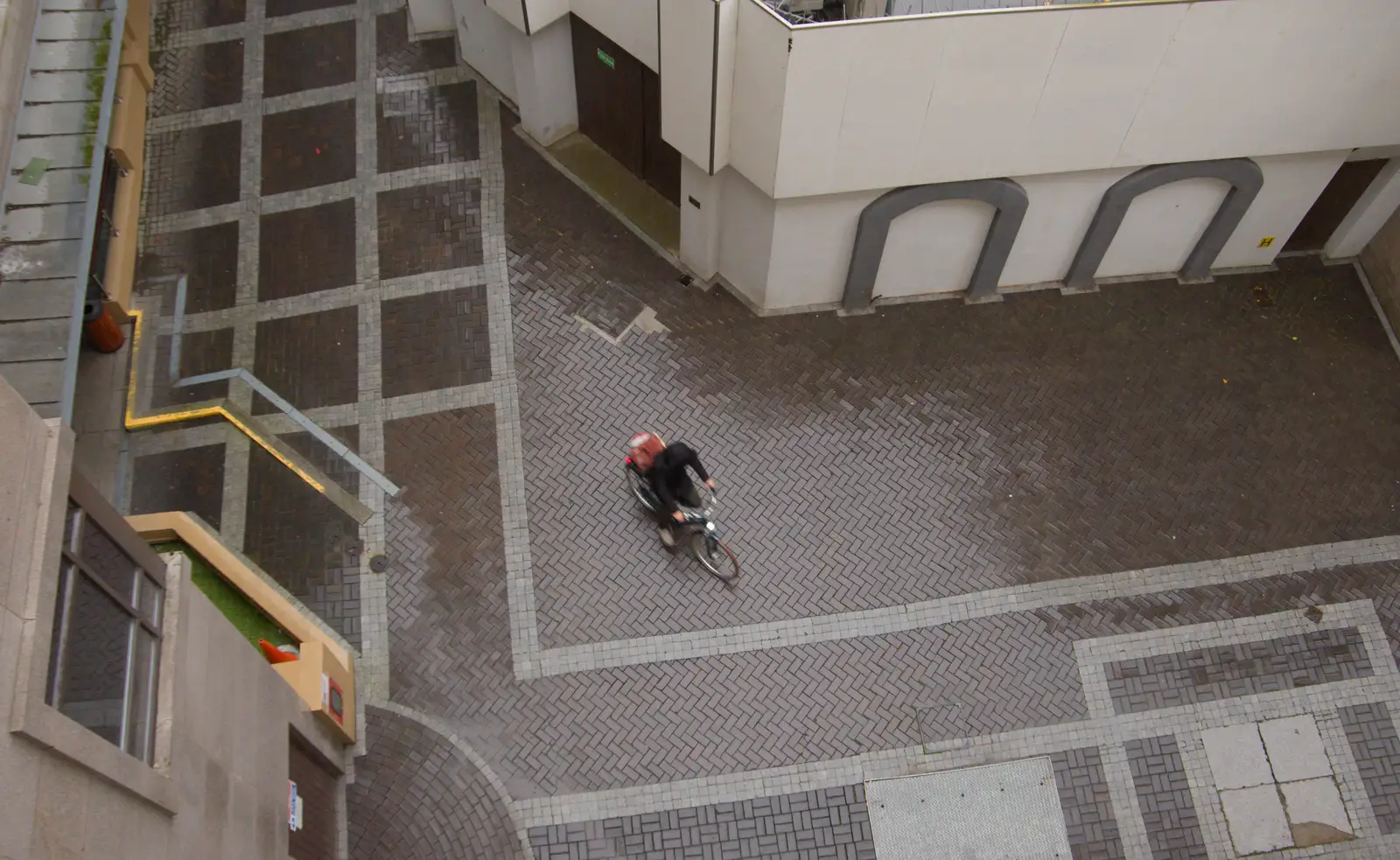 A cyclist in the hotel's back alley, from End of the Line 2: Bré to Blackrock, County Dublin, Ireland - 1st November 2025