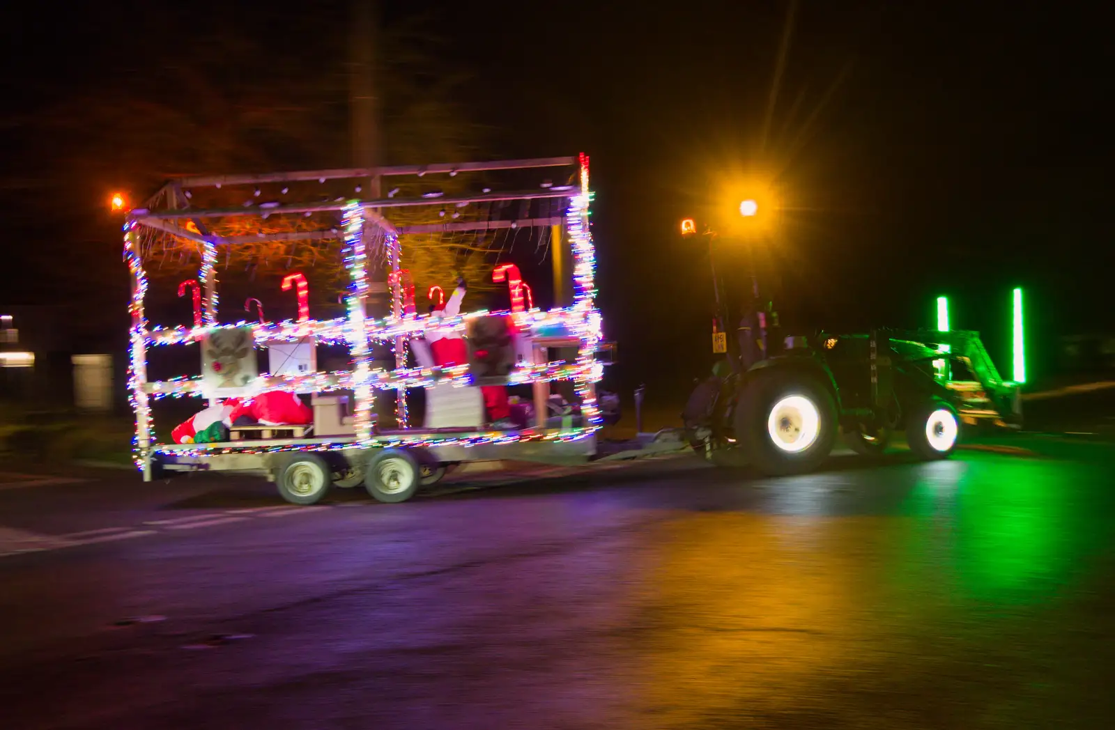 An illuminated trailer piles round the corner, from A Christmas Quiz and a Tractor Run, Brome, Suffolk - 20th December 2025
