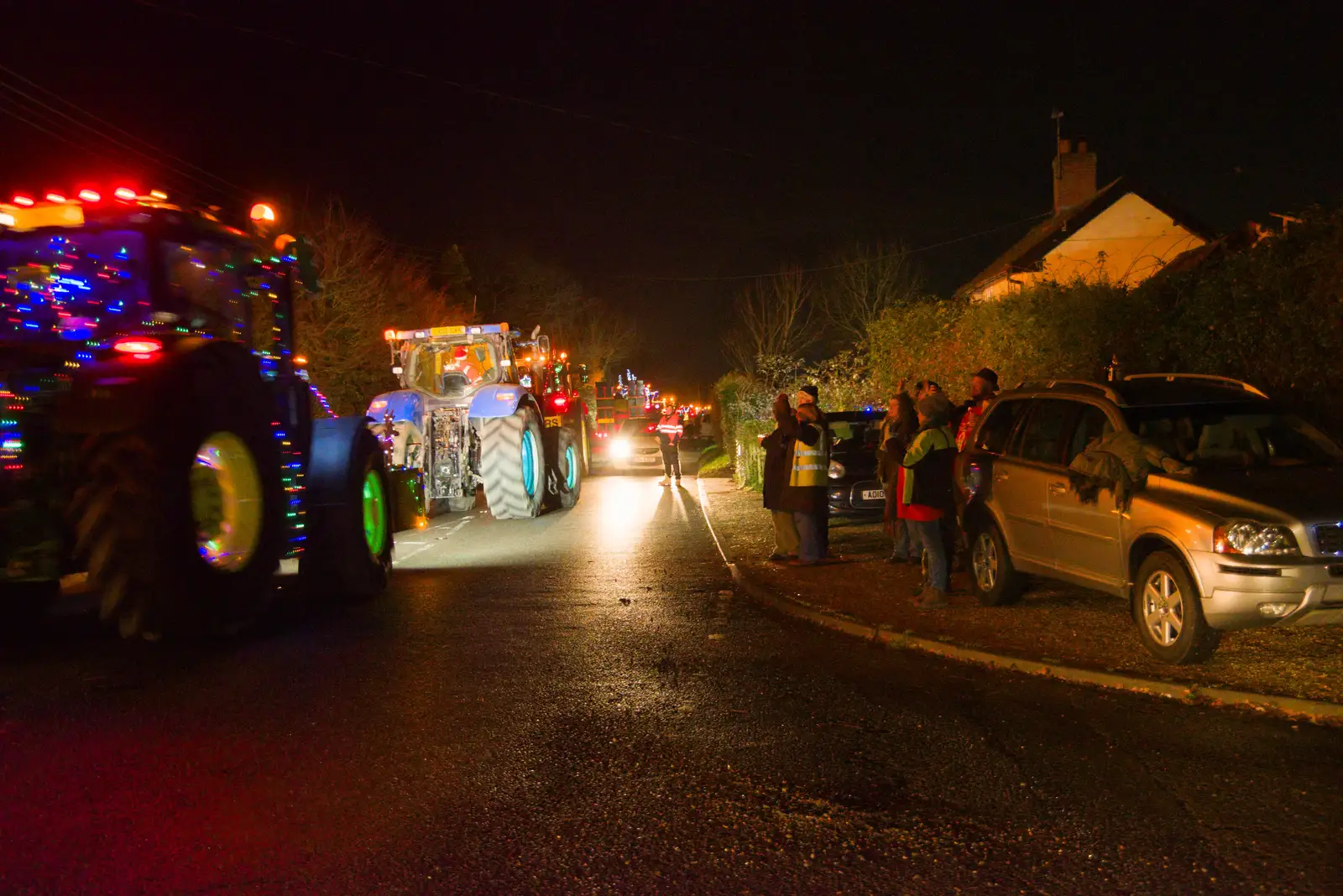 Tractors stream down the old B1077, from A Christmas Quiz and a Tractor Run, Brome, Suffolk - 20th December 2025