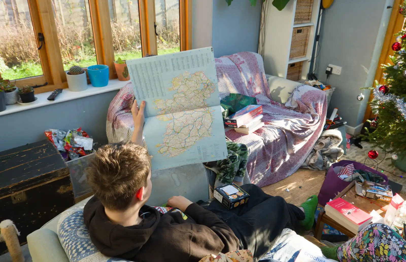 Fred looks at Ireland in the map book, from A Christmas Day Miscellany, Brome, Suffolk - 25th December 2025