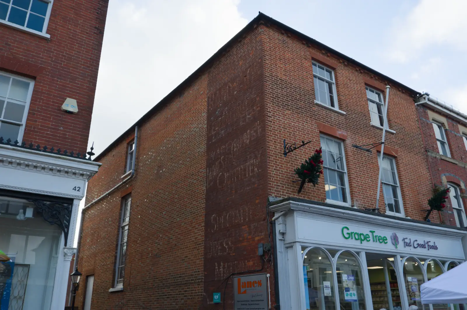 The remains of a Victorian shop sign on a wall, from New Milton and a Return to Lymington, Hampshire - 17th January 2026