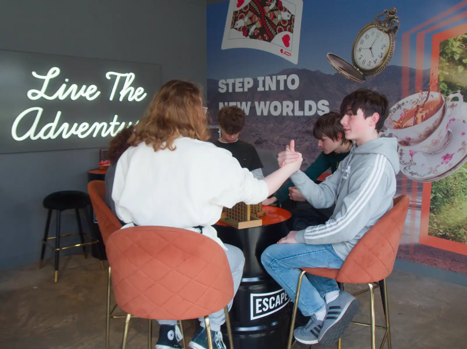 Isabella and Lewis have a quick arm-wrestle, from Harry's Escape Room, Timber Hill, Norwich - 28th March 2026