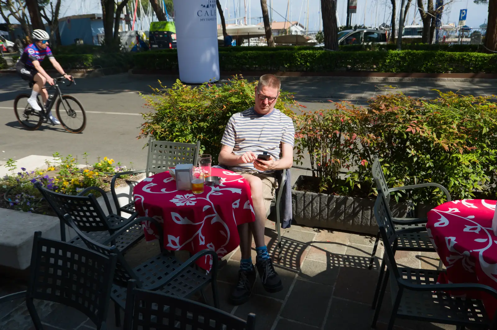 Sean's on his phone again as we stop for a beer, from Hauling Boats to Croatia: Toulon to Desenzano, Lake Garda, Italy - 11th April 2026