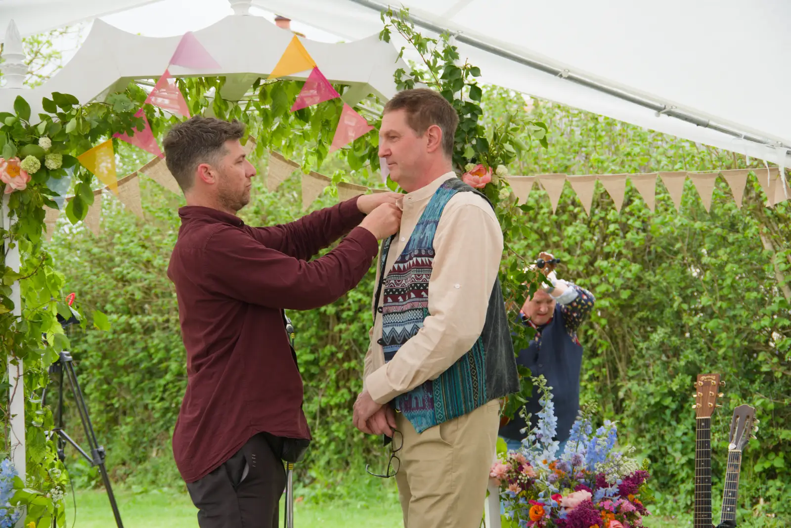 The photographer makes an adjustment to Sean, from Hannah and Sean's Wedding, King's Nympton, Devon - 3rd May 2026