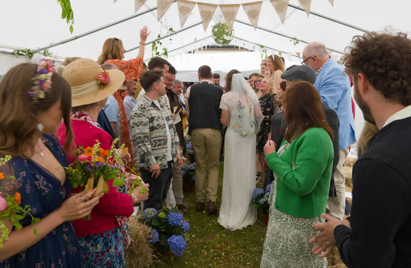 Sean and Hannah squeeze through the crowds, from Hannah and Sean's Wedding, King's Nympton, Devon - 3rd May 2026