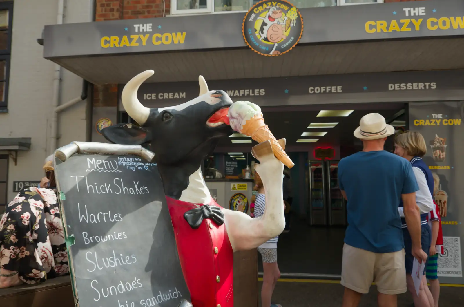 An ice-cream-licking cow on New Street, from A Bus Trip to Wells Next the Sea, Norfolk - 28th May 2026