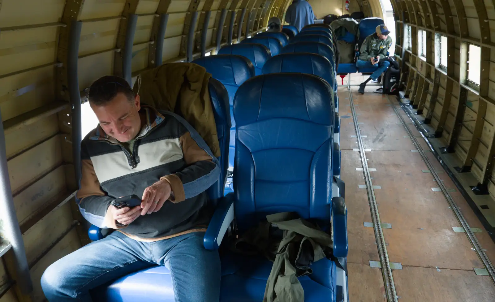 Clive checks his phone out, from Flying to Cherbourg on a C-47 Dakota, Normandy, France - 1st June 2026