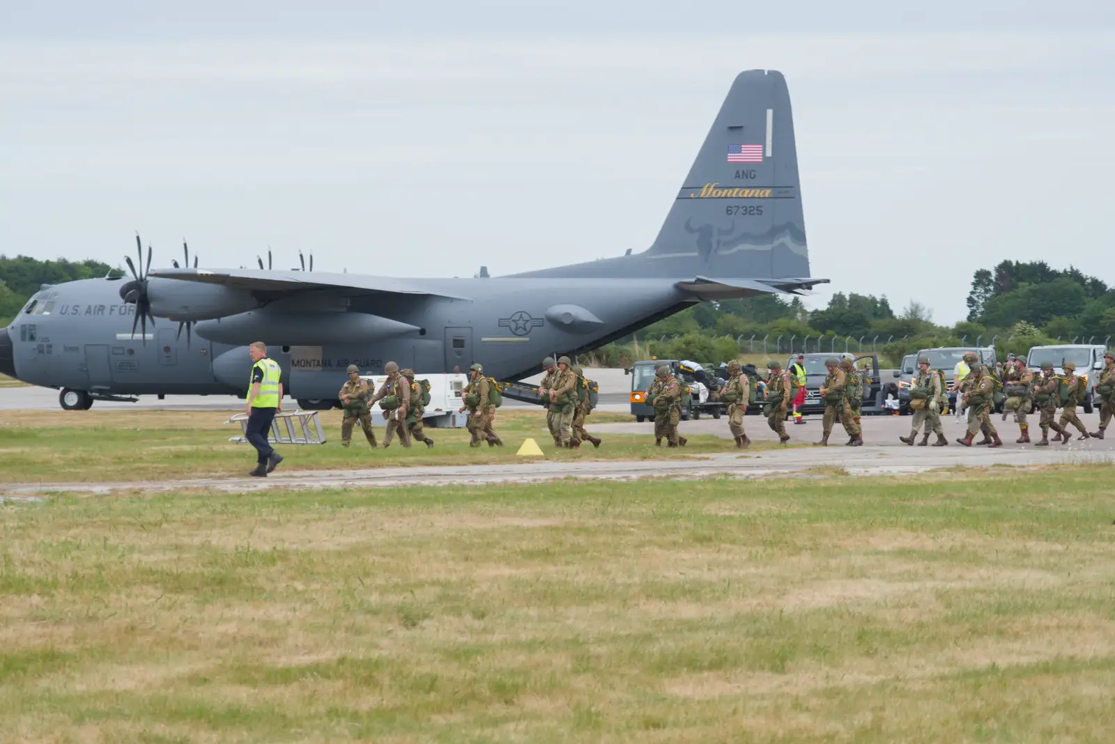 A new line of paratroopers walks past the C-130, from Flying to Cherbourg on a C-47 Dakota, Normandy, France - 1st June 2026