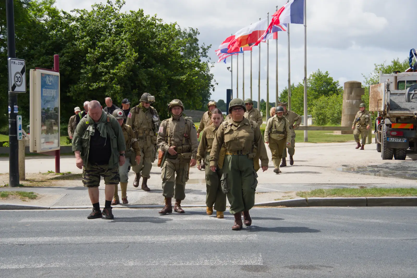 A bunch of re-enactors cross the road, from Pegasus Bridge, the British Memorial and Arromaches, Normandy - 2nd June 2026