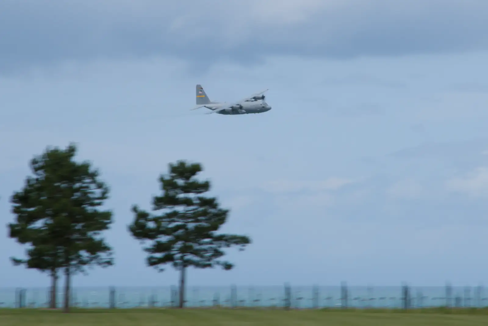 A C-130 Hercules buzzes the beach, from Pegasus Bridge, the British Memorial and Arromaches, Normandy - 2nd June 2026