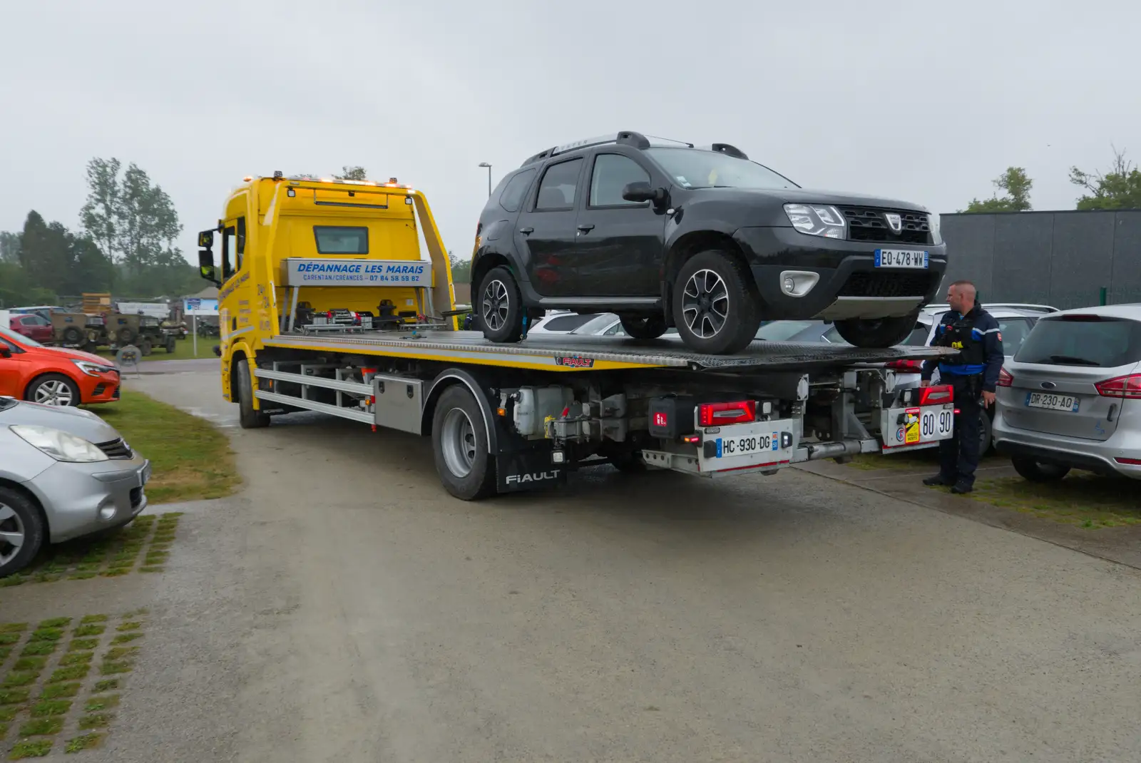 A car is hauled away for 'camping' in the car park, from Sainte-Mère-Élgise and Saint-Côme-du-Mont, Normandy, France - 3rd June 2026