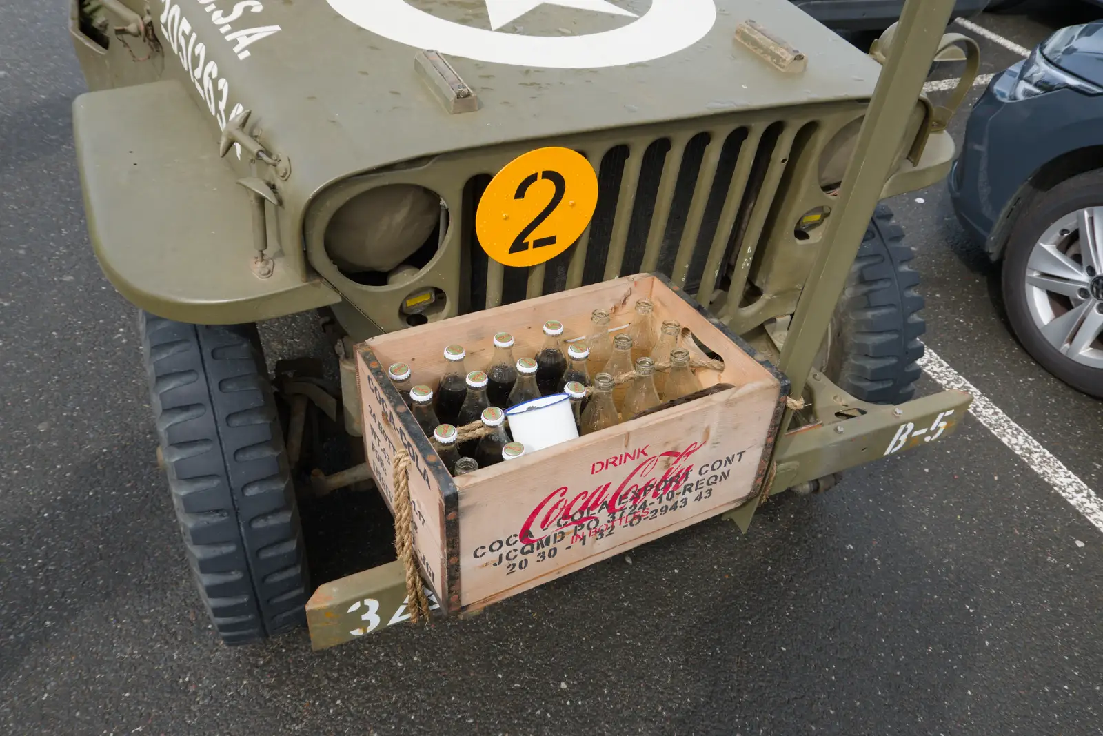 A jeep has a crate of Coca-Cola bottles on the front, from Sainte-Mère-Élgise and Saint-Côme-du-Mont, Normandy, France - 3rd June 2026