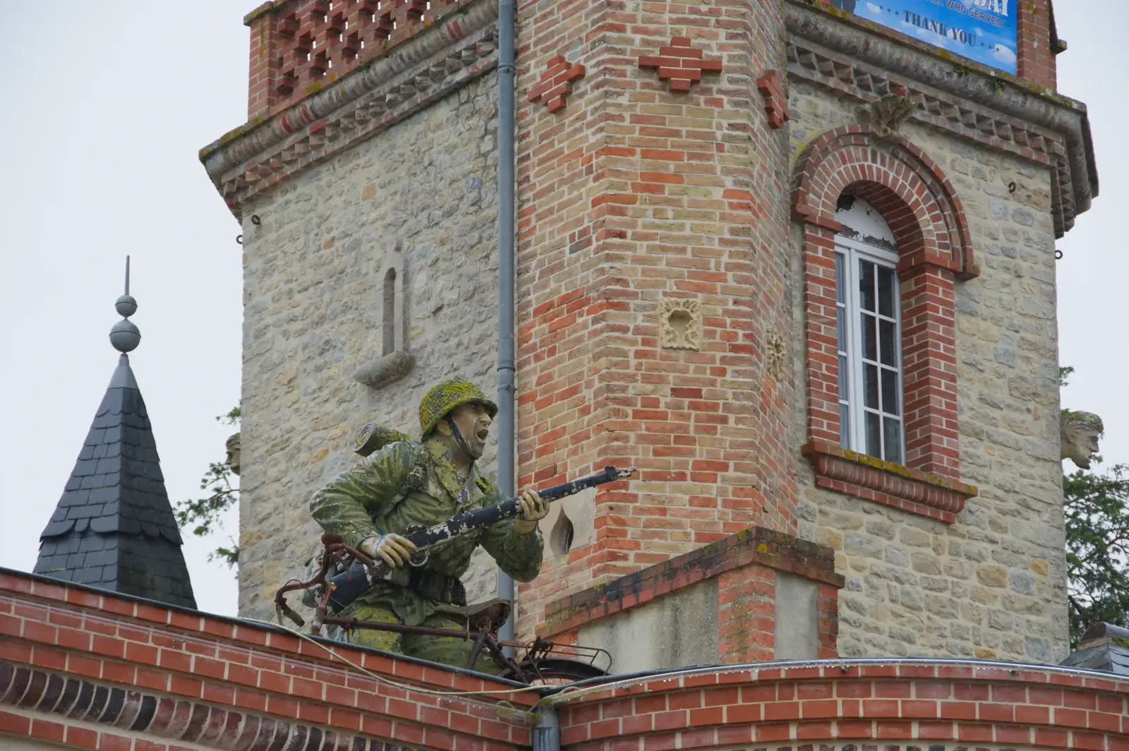 A paratrooper on a roof, from Sainte-Mère-Élgise and Saint-Côme-du-Mont, Normandy, France - 3rd June 2026