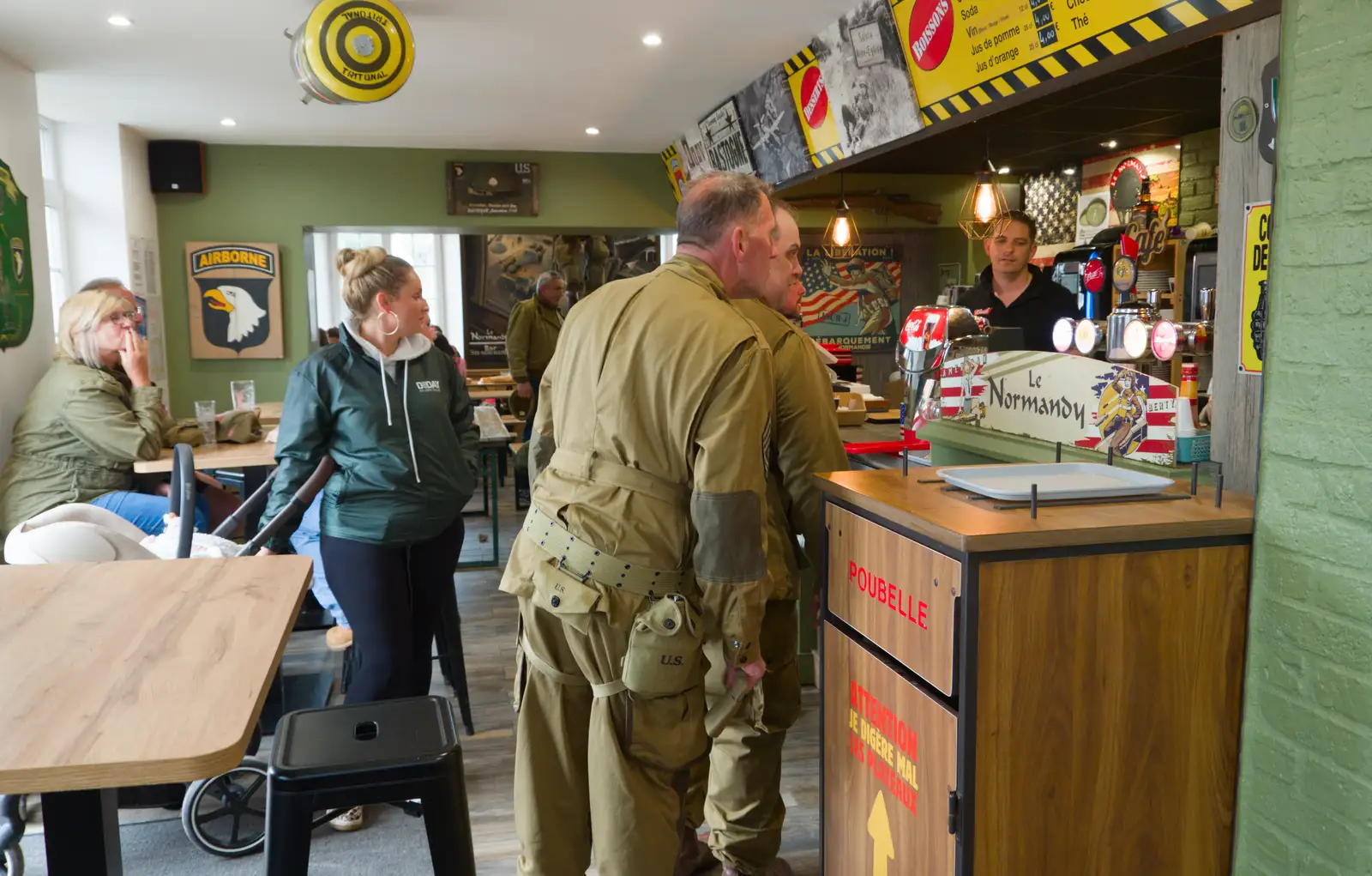 Re-enactors in the Au Domino café, from Sainte-Mère-Élgise and Saint-Côme-du-Mont, Normandy, France - 3rd June 2026