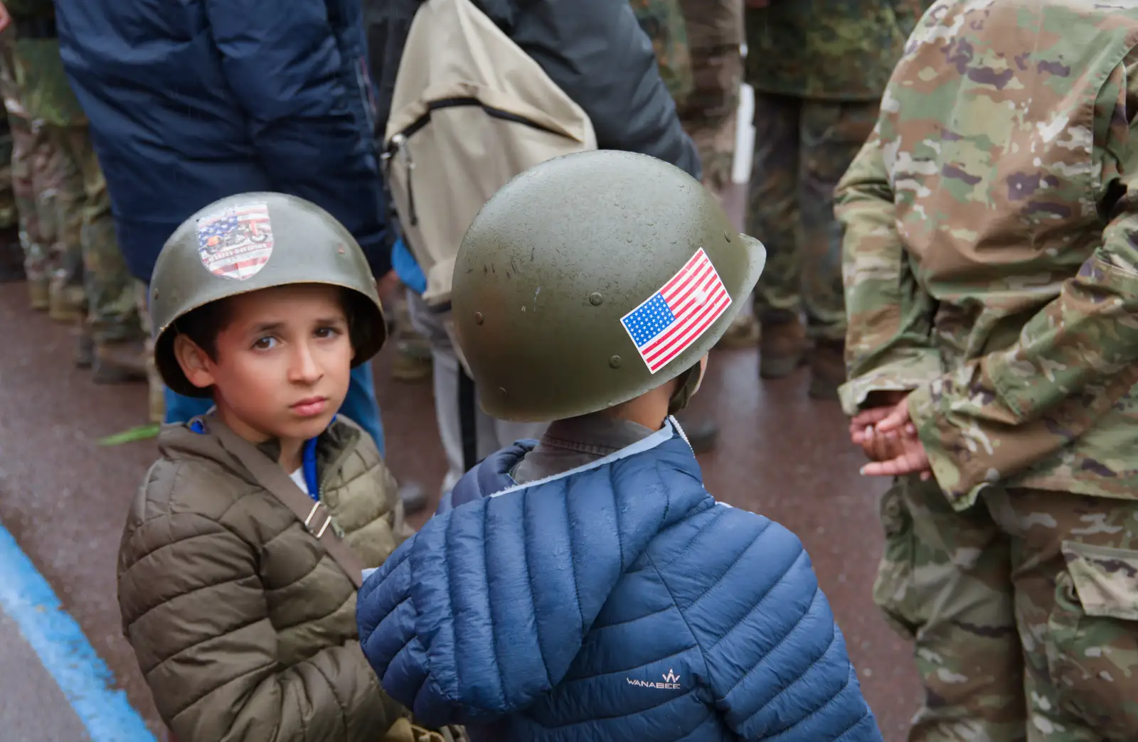 Small boys in GI helmets, from Sainte-Mère-Élgise and Saint-Côme-du-Mont, Normandy, France - 3rd June 2026