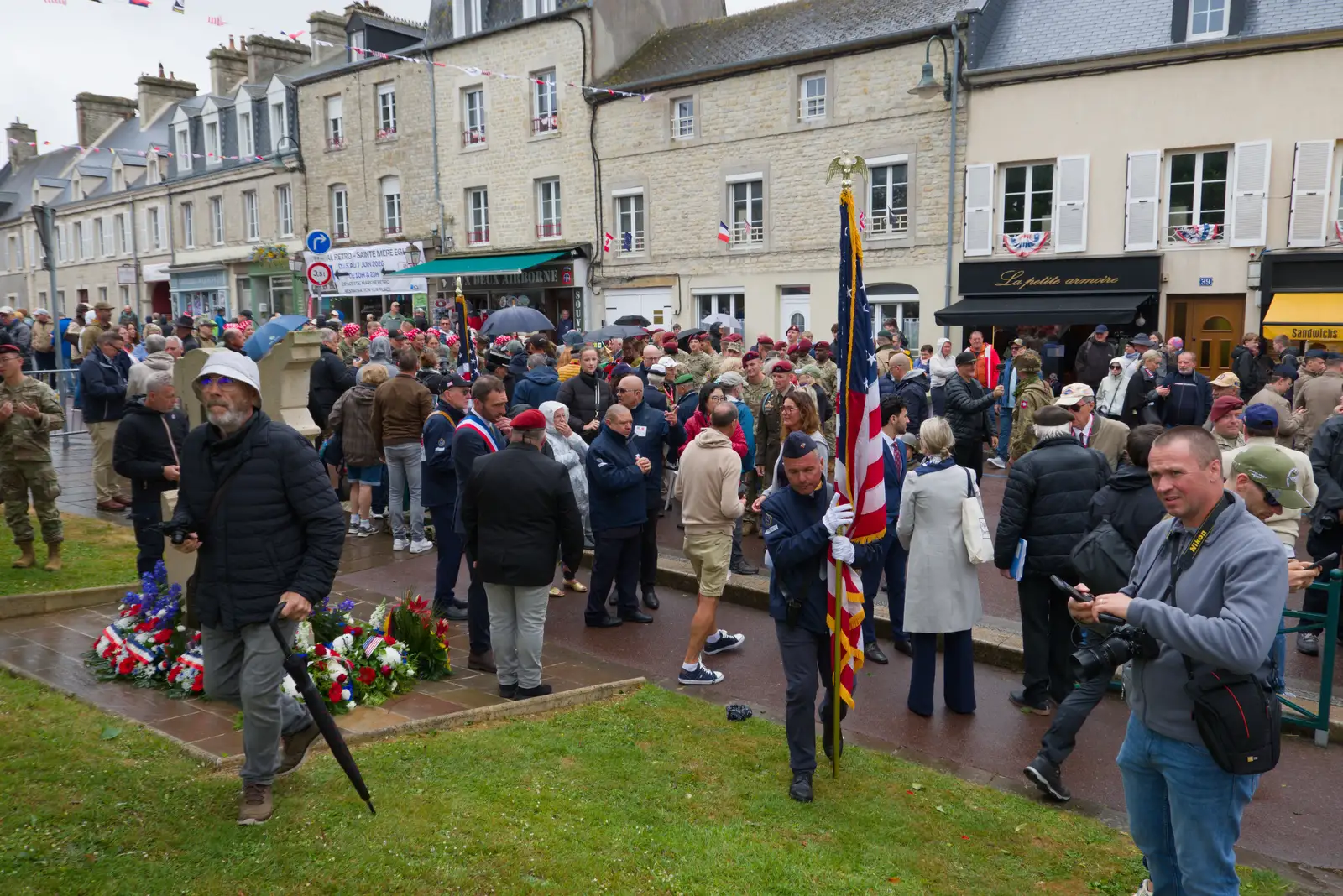 The milling throngs in St. Mère Église, from Sainte-Mère-Élgise and Saint-Côme-du-Mont, Normandy, France - 3rd June 2026