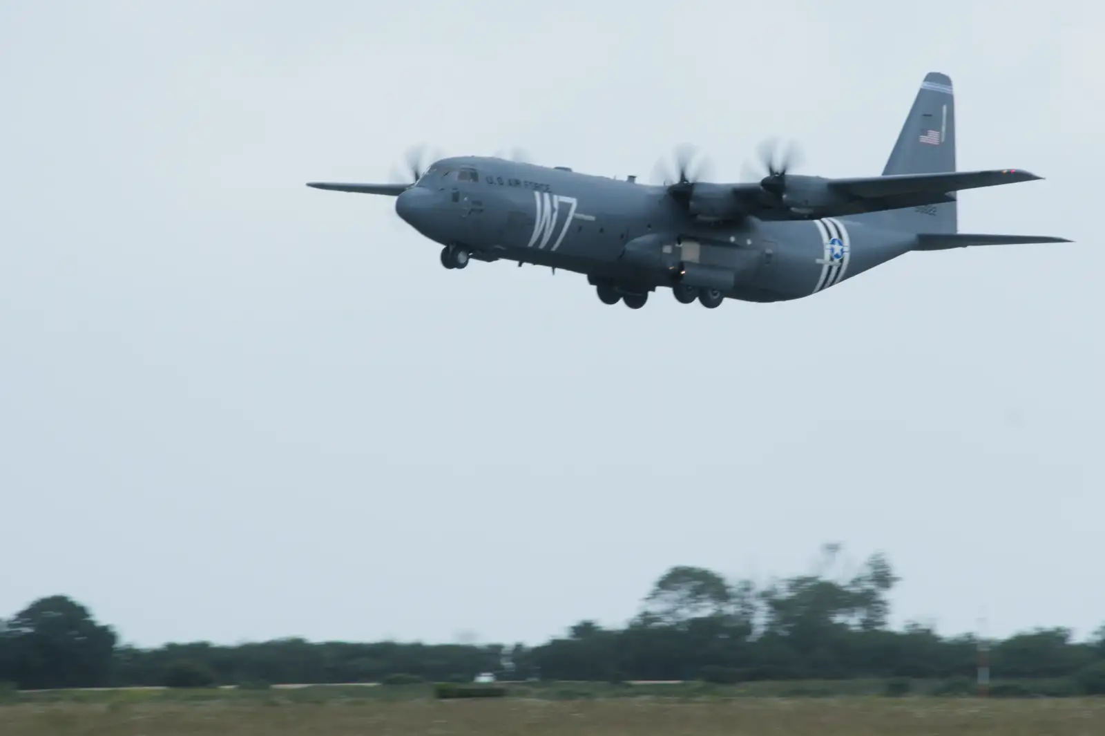 The 37th Airlift's Hercules flies with the W7 code, from Quettehou, Sainte-Marie-du-Mont and the D-Day Museum, Utah Beach - 4th June 2026