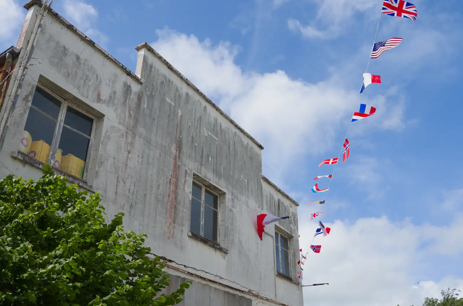 A run-down 1930s building flies the flags, from Quettehou, Sainte-Marie-du-Mont and the D-Day Museum, Utah Beach - 4th June 2026