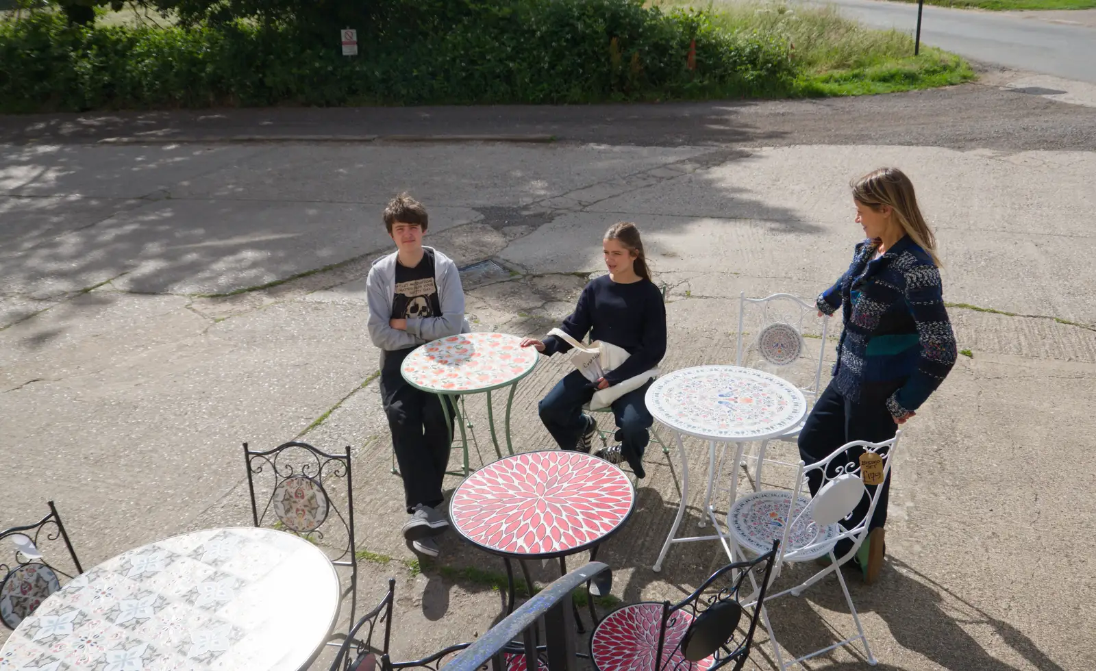 Fred and Scarlett sit at a bistro table, from Mellis Gardens and a Walk to Diss, Norfolk - 13th June 2026
