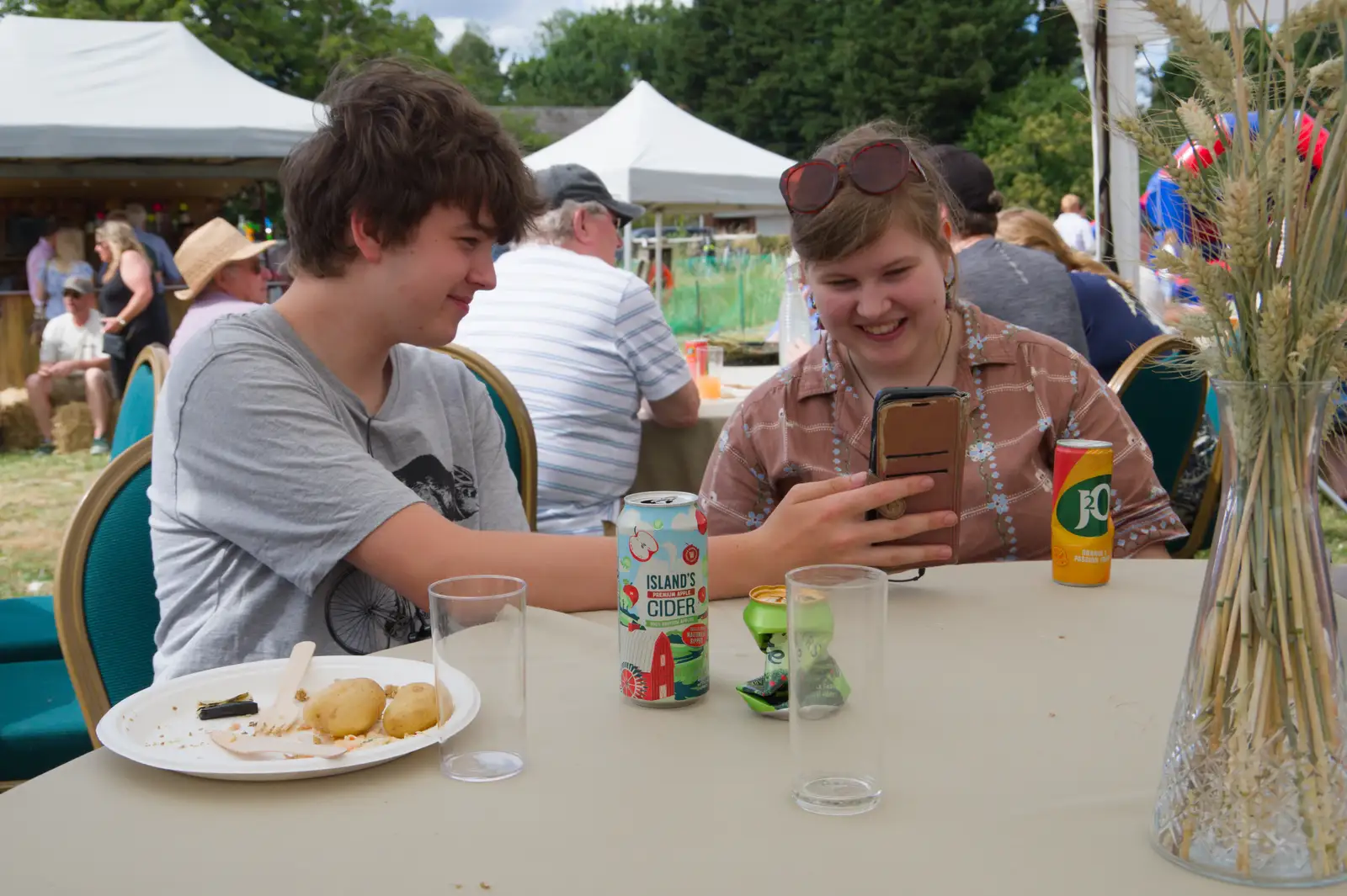 Fred shows off something amusing on his phone, from The Return of the Hog Roast, Thrandeston, Suffolk - 28th June 2026