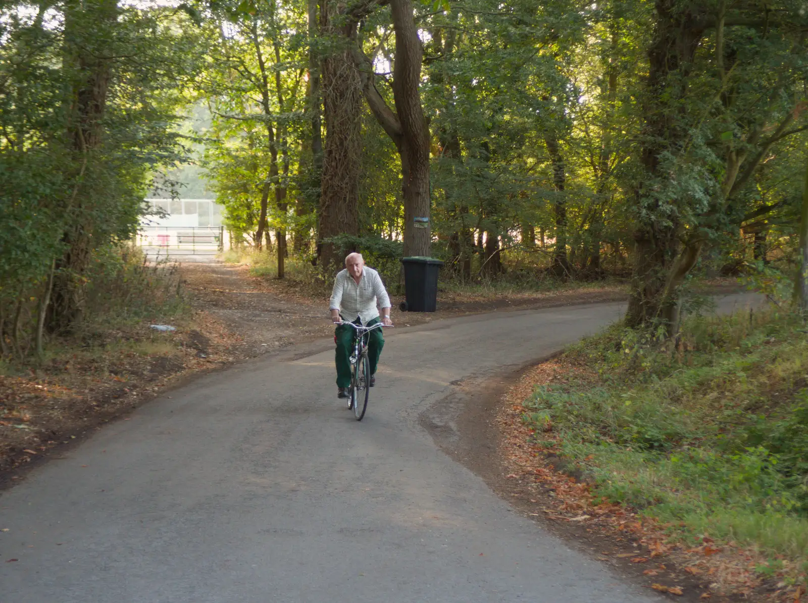 Mick the Brick cycles past Thornham cricket club, from A Wet Ride to the Four Horseshoes, Thornham - 19th August 2026