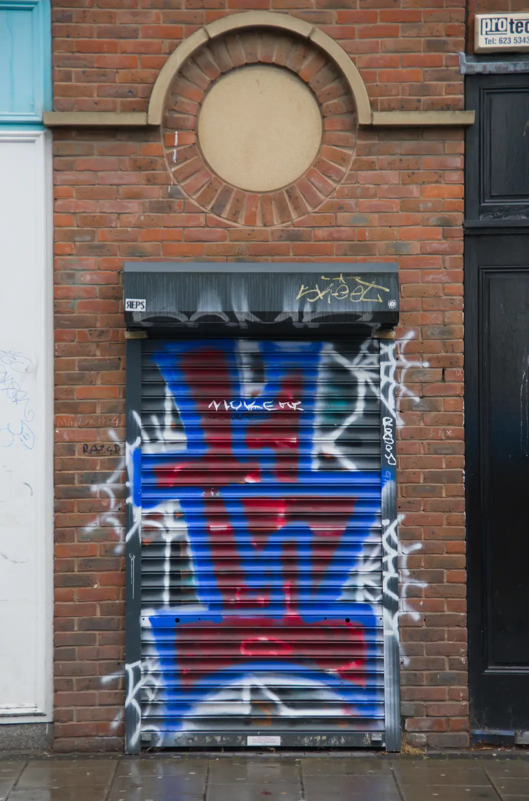 A graffiti'd roller door, from Castle Dargan Golf, Glangelvin and Pizza in Dún Laoghaire, Ireland - 28th August 2026