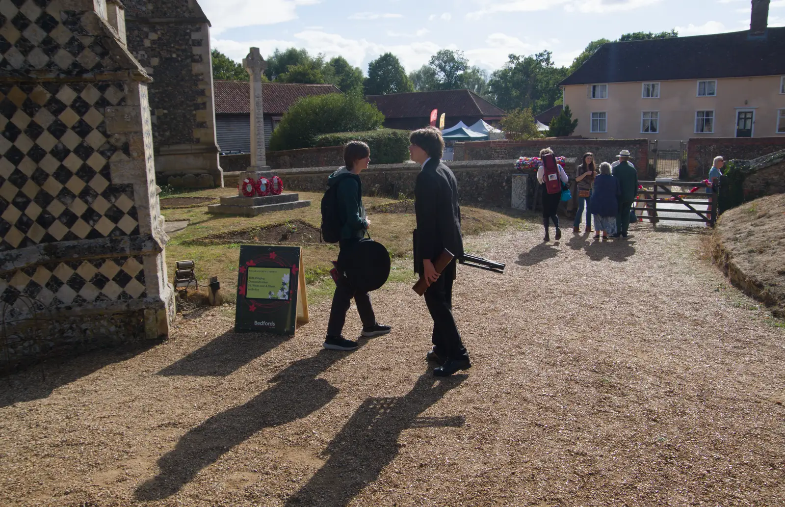 Harry and Fred walk past the church, from The GSB at Walsham and the Little Blues Band in Mellis, Suffolk - 31st August 2026