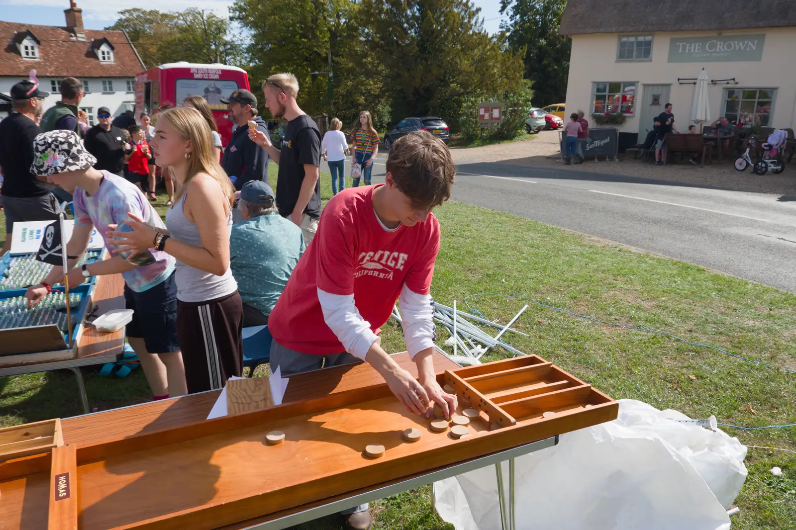 Archie picks up shove-board pieces, from The GSB at the Carnival, Pulham Market, Norfolk - 12th September 2026