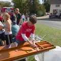 Archie picks up shove-board pieces, The GSB at the Carnival, Pulham Market, Norfolk - 12th September 2026