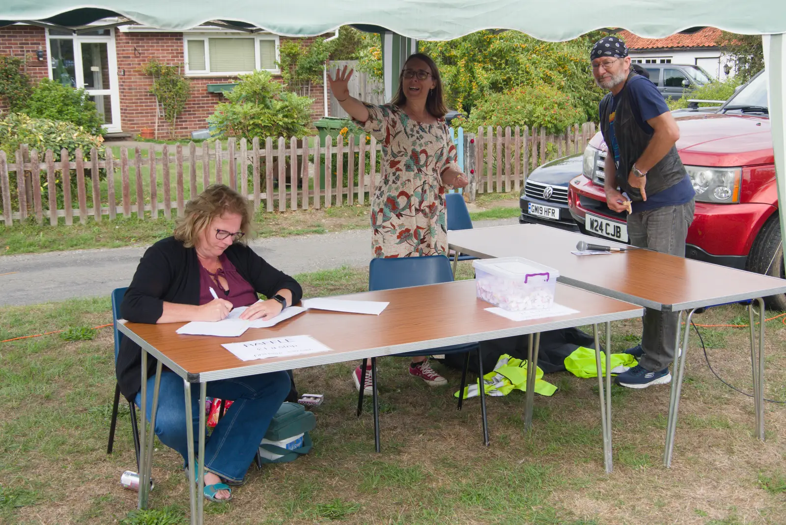 Sarah waves and Megan tallies something up, from The GSB at the Carnival, Pulham Market, Norfolk - 12th September 2026
