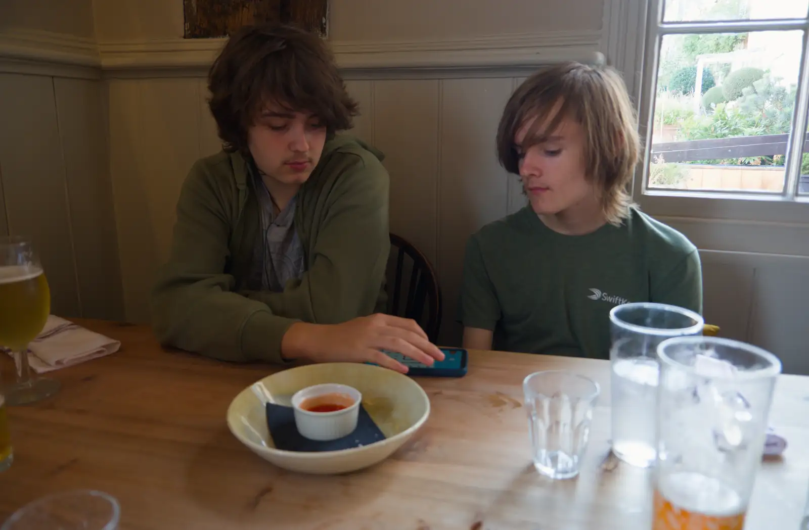 Fred and Harry play a phone-based game, from A Walk Around The Lion Pub, Debenham, Suffolk - 4th October 2026